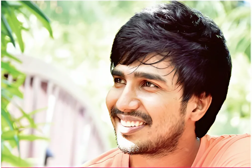 Rahul Gupta, a smiling young man outdoors in front of greenery